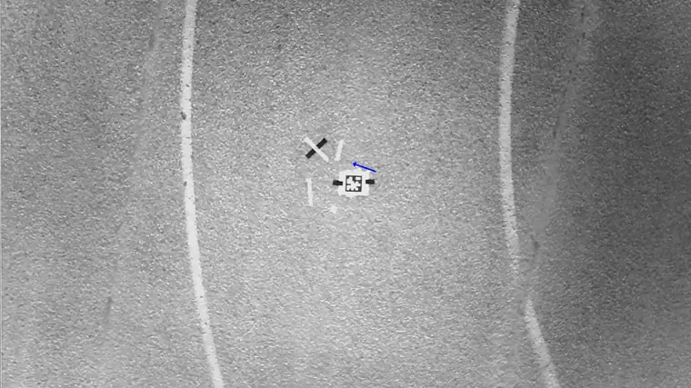 Repeat frame f01: the same ground seen on descent, with the correction vector the flight software drew on it.